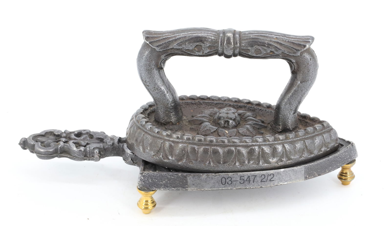 BELGIAN FLAT IRON: TEARDROP SHAPE WITH FLOWER MOTIF. MATCHING TRIVET WITH HANDLE AND BRASS FEET. 11" L. PLEASE READ CAREFULLY - Terms for Purchasing and Shipping of Auction Items. Please read carefully before bidding. T