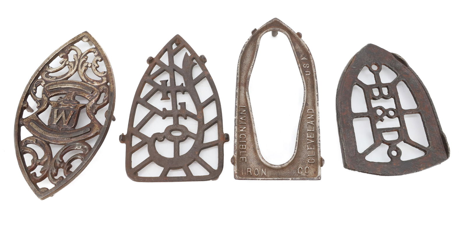 LOT OF FOUR ANTIQUE TRIVETS: INCLUDING: ONE MRKD. COLT, B&D, INVINCIBLE AND EMBOSSED "W" WITH FOX. 6" TO 7 1/2" LENGTHS. PLEASE READ CAREFULLY - Terms for Purchasing and Shipping of Auction Items. Please read carefully before bid