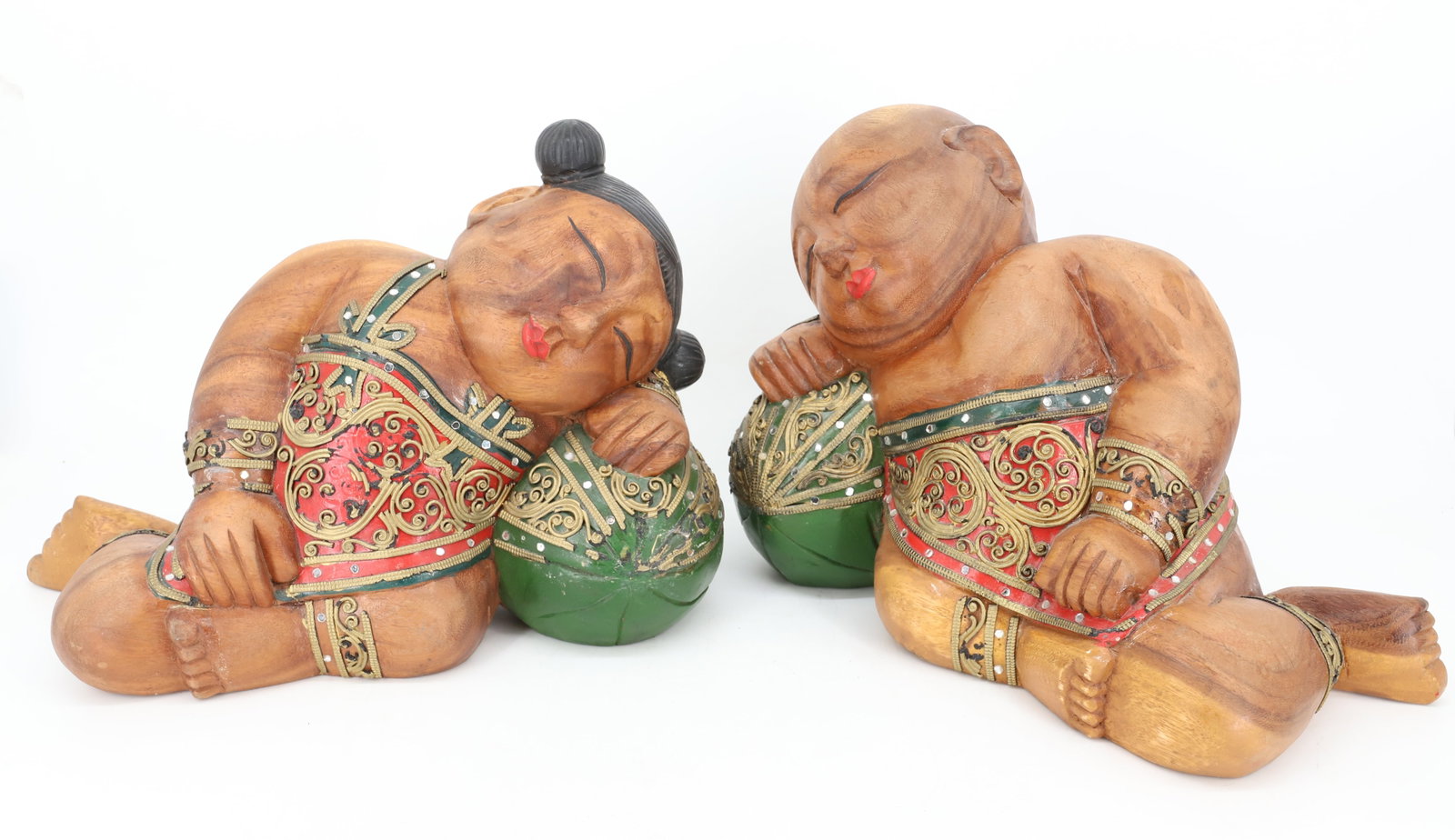 PAIR OF ASIAN WOOD CARVINGS: BOY AND GIRL RESTING ON MELONS. PAINTED AND ADORNED. 14" L. PLEASE READ CAREFULLY - Terms for Purchasing and Shipping of Auction Items. Please read carefully before bidding. Hartzell’s Auction G