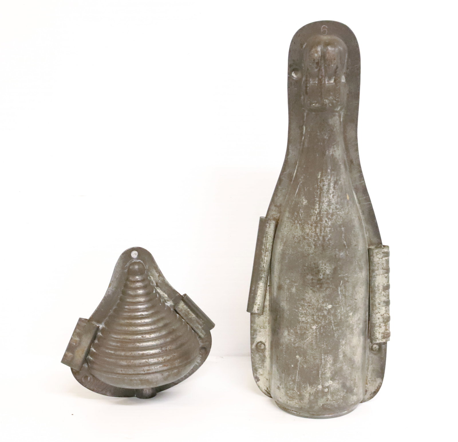 CHAMPAGNE BOTTLE AND SPINNING TOP CHOCOLATE MOLDS: BOTTLE IMPRESSED "6" AT TOP. TOTAL SIZE 11 1/4" H. TOP 4 3/4" H. PLEASE READ CAREFULLY - Terms for Purchasing and Shipping of Auction Items. Please read carefully before bidding. Hartzell’s Auct