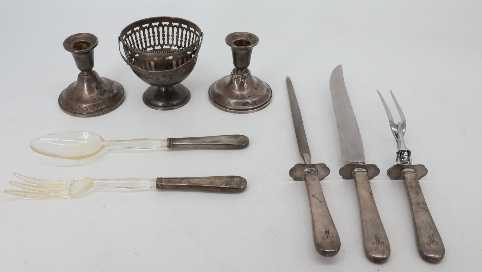 LOT OF STERLING SILVER: INCLUDING: WEIGHTED CANDLEHOLDERS, MONOGRAMMED FOOTED BASKET WITH HANDLE AND SERVING PIECES WITH STERLING HANDLES. PLEASE READ CAREFULLY - Terms for Purchasing and Shipping of Auction Items. Please re