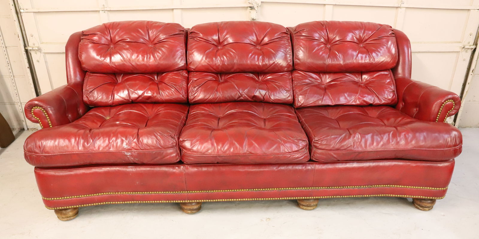 HANCOCK & MOORE LEATHER COUCH: RED LEATHER WITH BRASS TACKING. 31" X 85" X 36". DUE TO WEIGHT AND SIZE CAN NOT BE SHIPPED. WINNING BIDDER IS RESPONSIBLE FOR PICK-UP IN 18013 OR ARRANGING SHIPPING. PLEASE READ CAREFULLY - Terms for