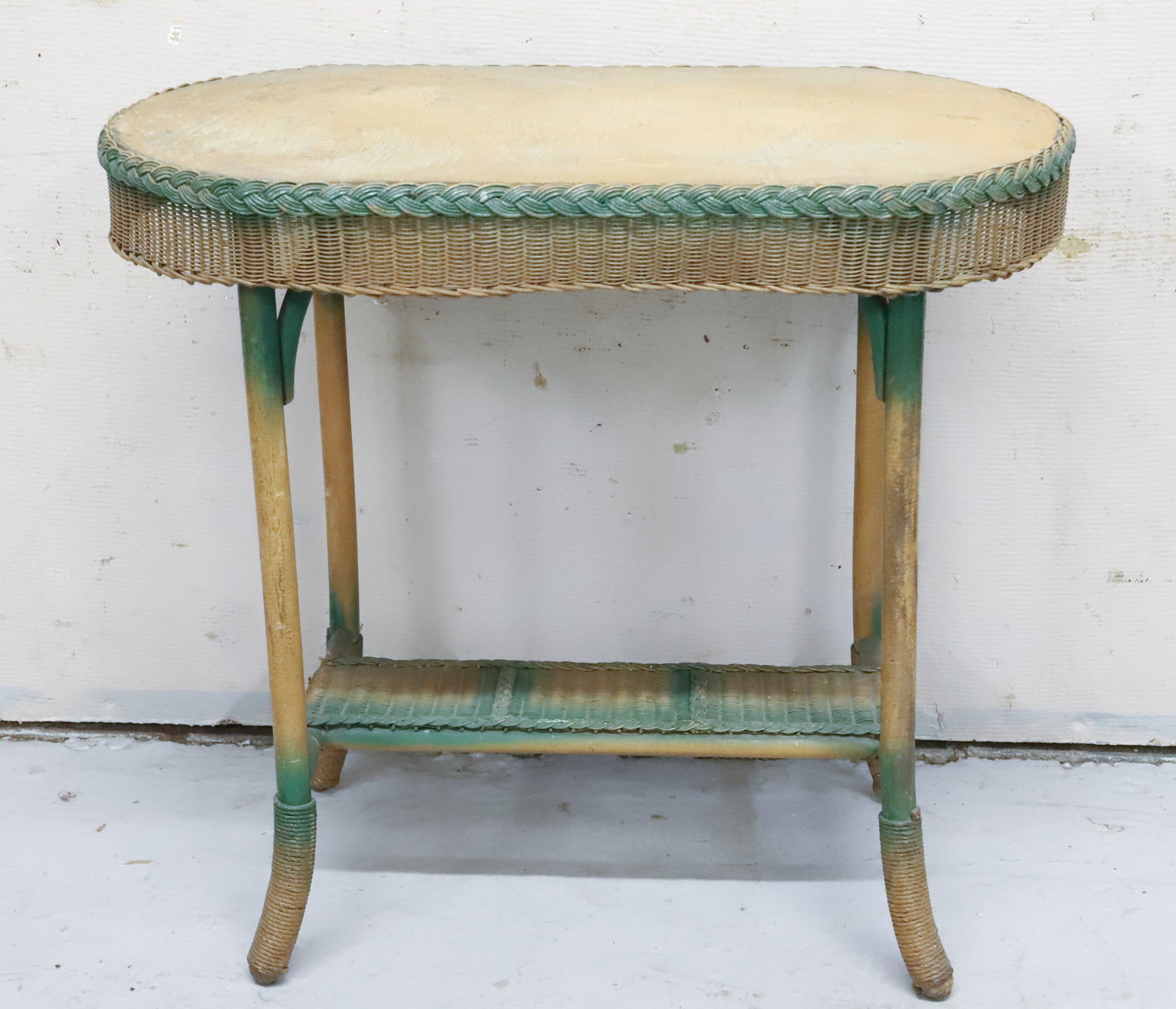 OVAL WICKER-STYLE SIDE TABLE: GREEN HIGHLIGHTS. FIBRE FURNITURE. GARDNER, ME 28" X 31" X 18 1/2". DUE TO WEIGHT AND SIZE CAN NOT BE SHIPPED. WINNING BIDDER IS RESPONSIBLE FOR PICK-UP IN 18013 OR ARRANGING SHIPPING. PLEASE READ CAR