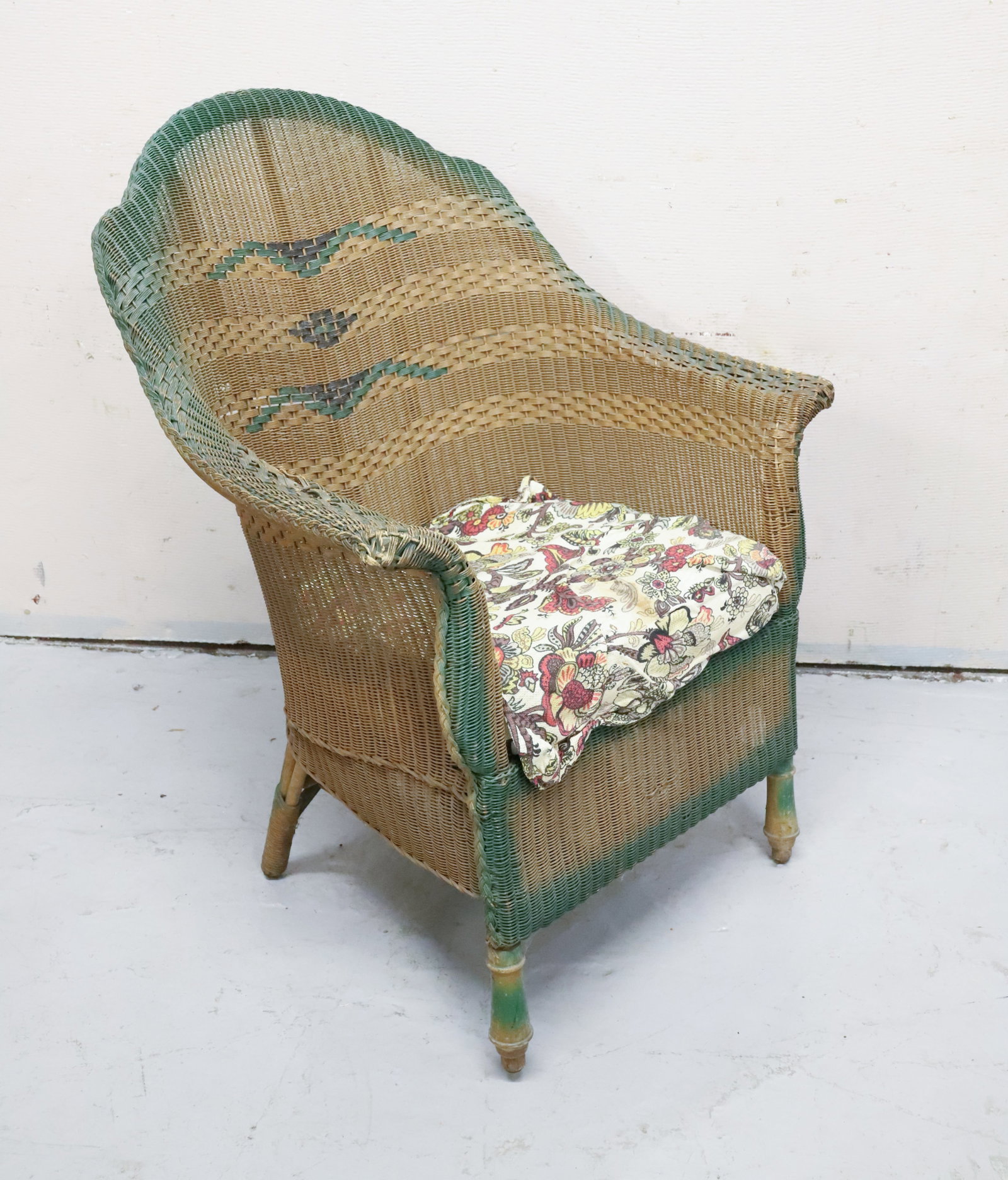 WICKER-STYLE ARMCHAIR WITH CUSHION: GREEN HIGHLIGHTS. TAG ON BACK "FIBRE FURNITURE, GARDNER, ME". 37" X 29" X 18". DUE TO WEIGHT AND SIZE CAN NOT BE SHIPPED. WINNING BIDDER IS RESPONSIBLE FOR PICK-UP IN 18013 OR ARRANGING SHIPPING. PLEA