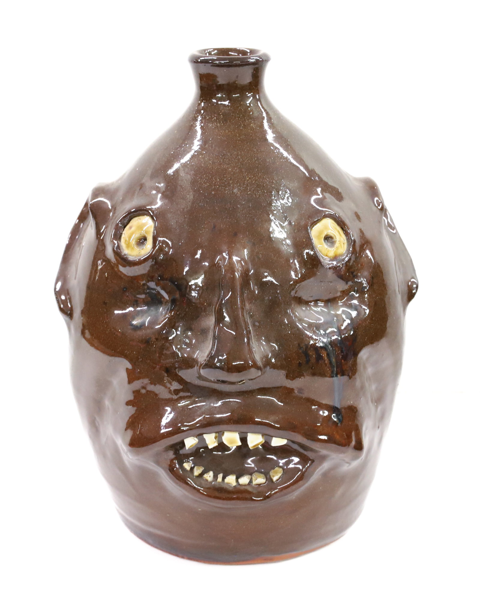 JEFF STANDRIDGE POTTERY FACE JUG: DARK BROWN GLAZE, WHITE EYES, AND SHARD TEETH - MARKED; GILLSVILLE, GA 6-99 ON BOTTOM - 9 3/4" H PLEASE READ CAREFULLY - Terms for Purchasing and Shipping of Auction Items. Please read carefully befor