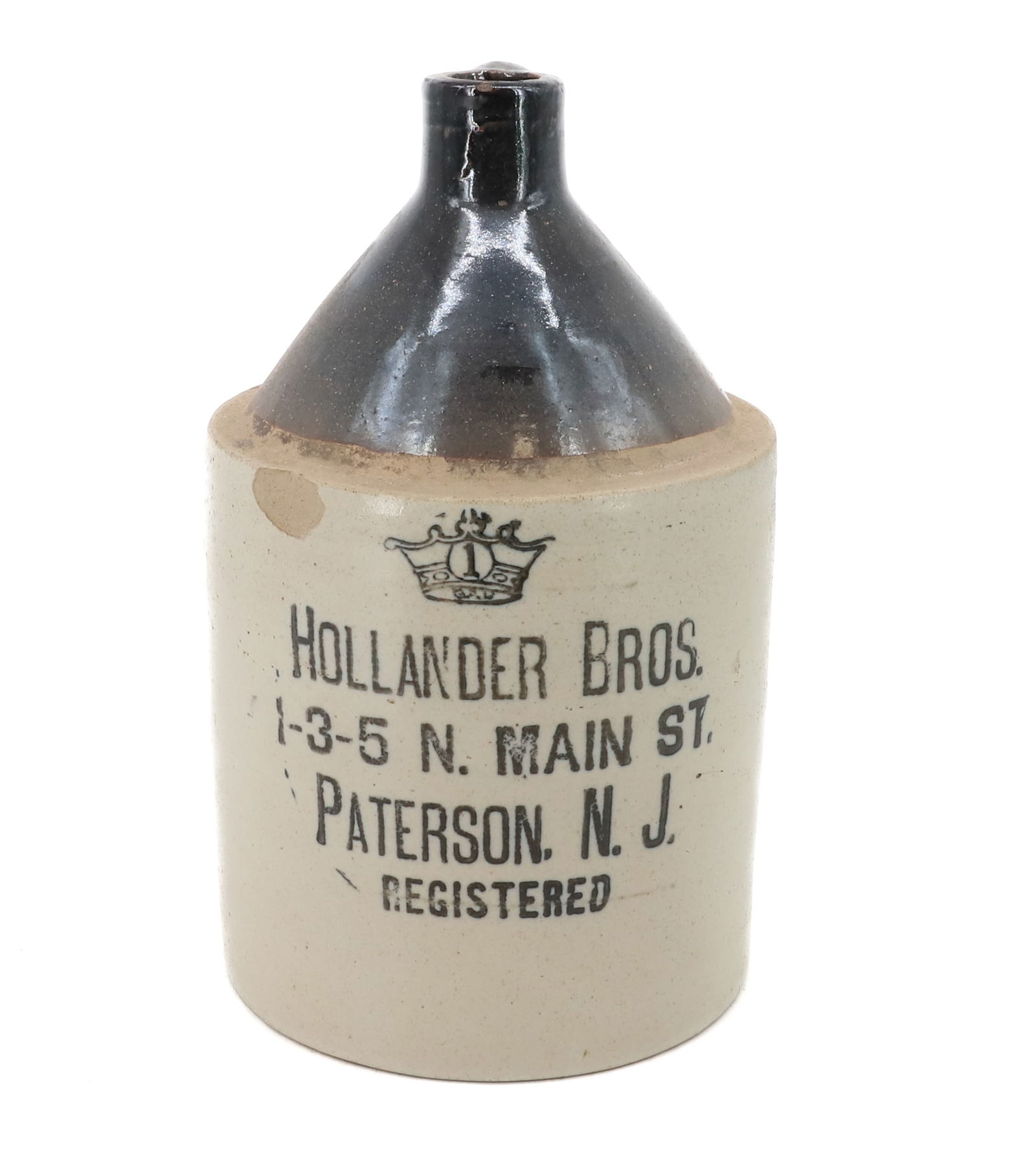 HOLLANDER BROS. STONEWARE ADVERTISING JUG: MRKD. "1" IN CROWN. "1-3-5 N. MAIN ST. PATERSON, N.J. REGISTERED". 11 1/4" H. PLEASE READ CAREFULLY - Terms for Purchasing and Shipping of Auction Items. Please read carefully before bidding. Hartzell