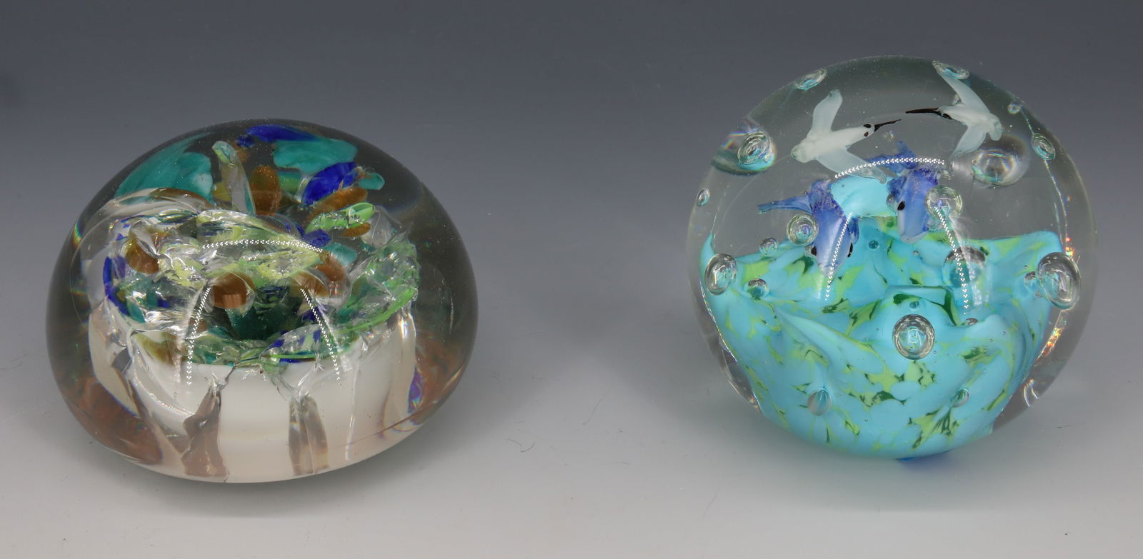 (2) ART GLASS PAPERWEIGHTS: DOLPHINS AND SEAGULLS (UNSIGNED) WITH, UNSIGNED ABSTRACT FLORAL. WHITE INTERIOR BASE. 3 3/4" D. PLEASE READ CAREFULLY - Terms for Purchasing and Shipping of Auction Items. Please read carefully before