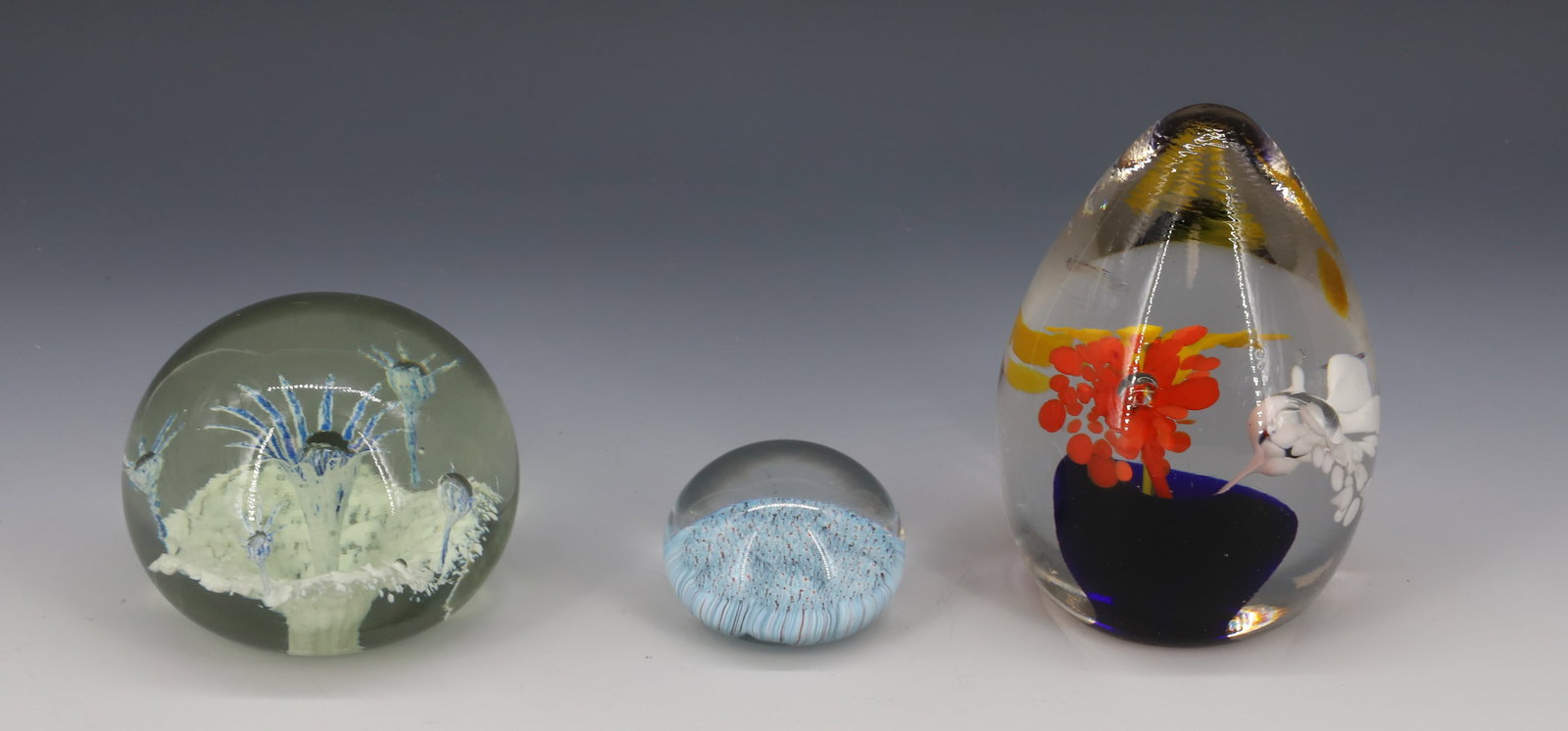 LOT OF (3) UNSIGNED GLASS PAPERWEIGHTS: (3) VARIOUS SIZES AND SHAPES. 2" TO 3 1/4" DIAMETERS. TALLEST IS 4 1/2" H. PLEASE READ CAREFULLY - Terms for Purchasing and Shipping of Auction Items. Please read carefully before bidding. Hartzell