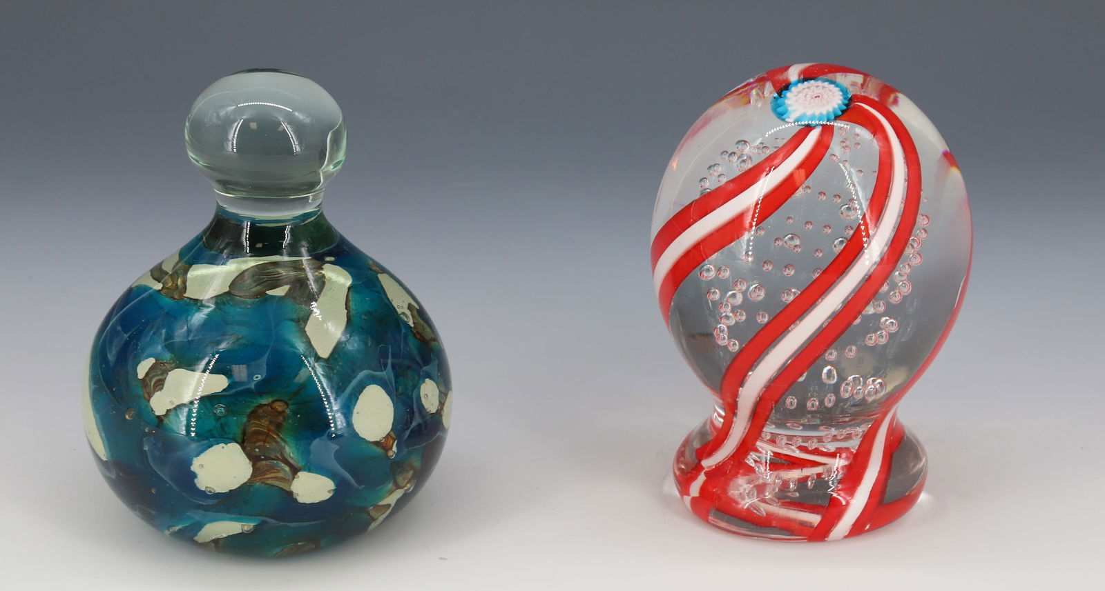 (2) ART GLASS PAPERWEIGHTS: BLUE/GREEN/BROWN EXAMPLE WITH KNOB HANDLE SGND. MOLINA. 4 1/4" H. RED/WHITE SWIRLED WITH BLUE/WHITE FLORAL ON TOP. UNSIGNED. 4 1/4" H. PLEASE READ CAREFULLY - Terms for Purchasing and Shipping of Auct