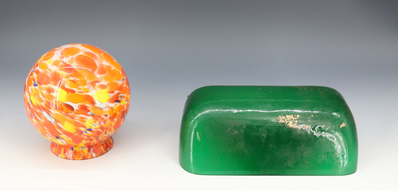 (2) VINTAGE GLASS SHADES: ONE EMERALD GREEN BANKER'S LIGHT SHADE 8 3/4" X 5 1/2". END OF DAY BALL SHAPED GLOBE IN ORANGE/WHITE/BLUE. 5" D. FITTER 3 1/8". PLEASE READ CAREFULLY - Terms for Purchasing and Shipping of Auction Ite