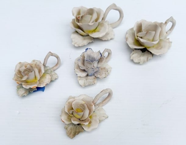 BONE CHINA FLORAL CANDLEHOLDERS: PAIR OF LARGE FLOWERS 4 3/4" L. AND (3) SMALLER FLORAL 3 1/2" L. COLORED HIGHLIGHTS. ONE SMALLER SGND. ON BOTTOM. PLEASE READ CAREFULLY - THIS IS AN ONLINE ONSITE ONLY AUCTION - Terms for Purchasing a