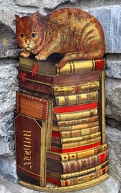 FOLK ART CAT ON PILE OF BOOKS