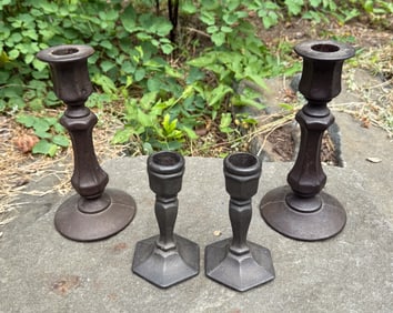 (4) CAST IRON CANDLESTICKS