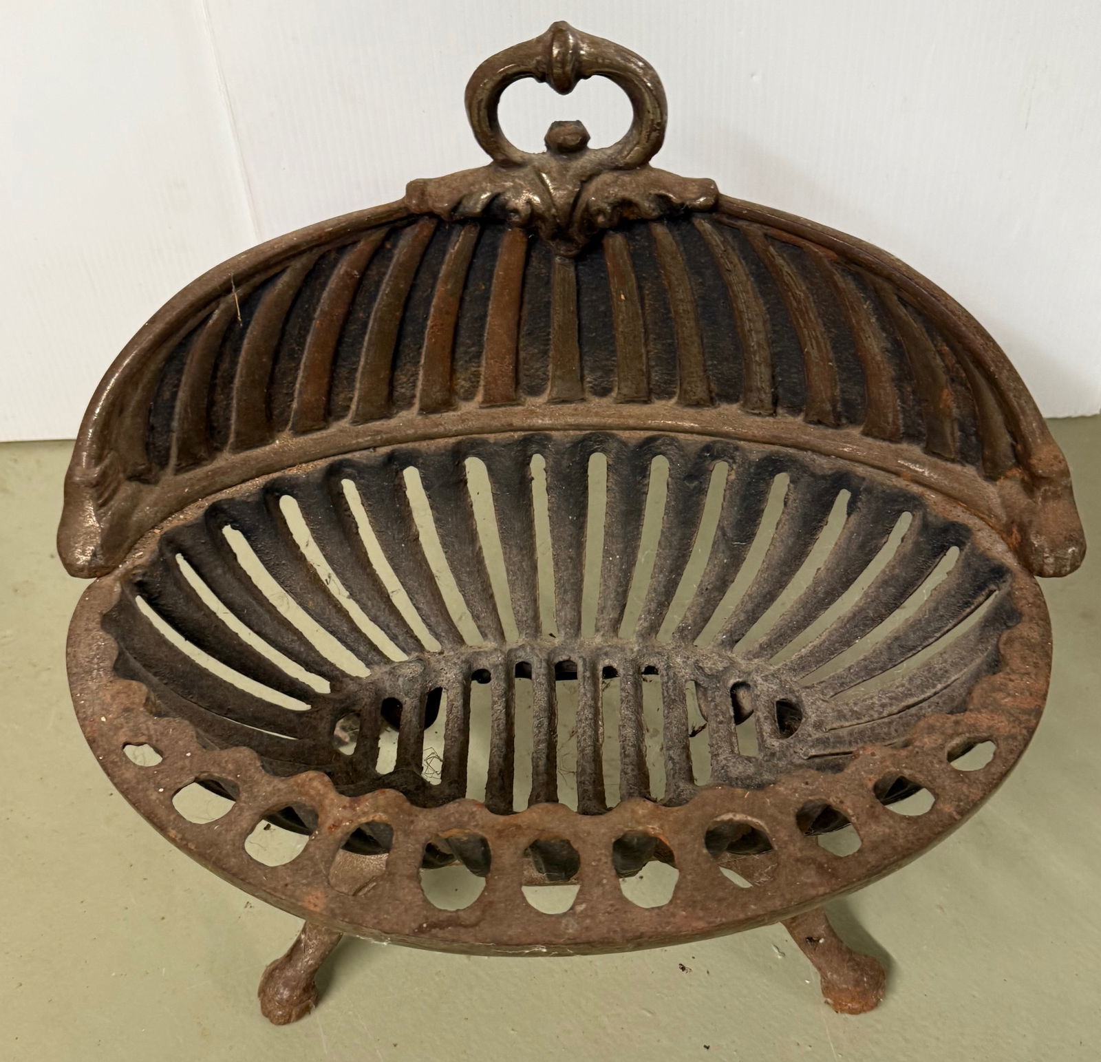 CAST IRON STOVE PIECE: CAST IRON, FOR HOLDING LOG OR KINDLING - 16" X 17" X 12" CONDITION REPORTS ARE BASED ON VISUAL INSPECTION. IF YOU HAVE ANY FURTHER QUESTIONS REGARDING CONDITION OF AN ITEM, PLEASE CONTACT US FOR A MOR