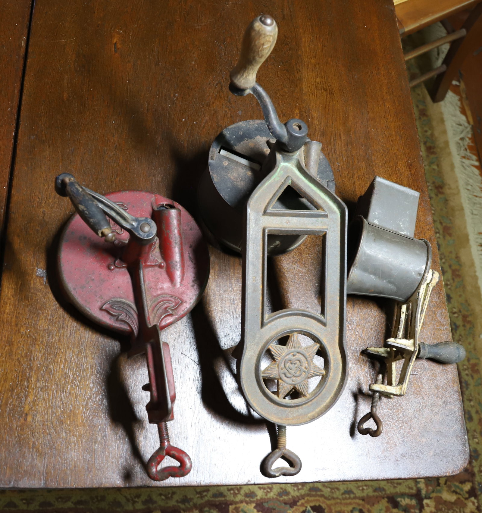 LOT OF ANTIQUE SLICERS / GRINDERS: ROUND PAINTED RED EXAMPLE MRKD. GLQ. ANOTHER, WITH SEVEN POINT STAR BRANDING 11" L. SMALLEST HAS WHITE PAINT MRKD. "333". PLEASE READ CAREFULLY - THIS IS AN ONLINE ONLY AUCTION - Terms for Purchasing