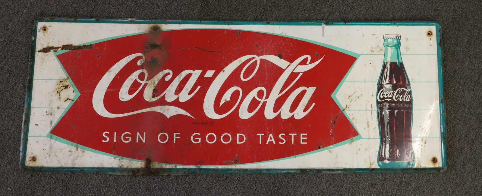 VINTAGE COCA-COLA SIGN: "SIGN OF GOOD TASTE". MRKD. "MCA 065" AND "010". 11 3/4" X 31 1/2". PLEASE READ CAREFULLY - Terms for Purchasing and Shipping of Auction Items. Please read carefully before bidding. Hartzell?s Auction