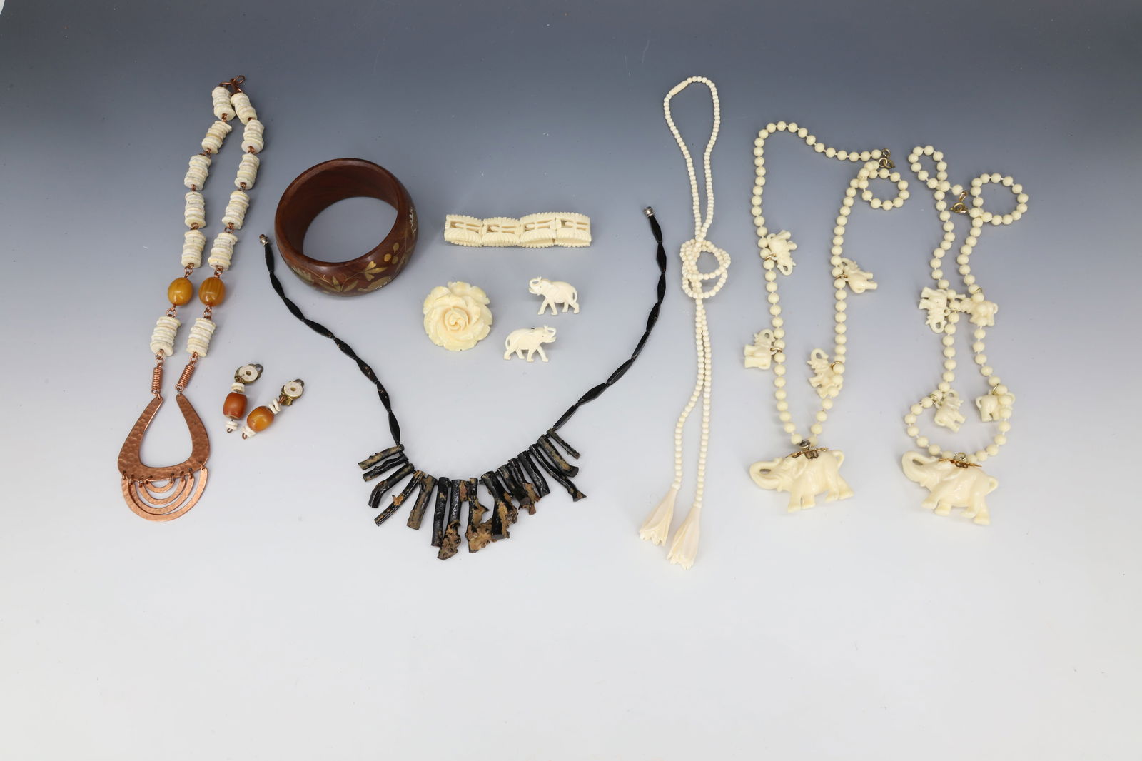 CONTEMPORARY JEWELRY LOT: CARVED BONE NECKLACE,ELEPHANT EARRINGS, ROSE BROOCH AND CARVED BRACELET, PLASTIC ELEPHANT NECKLACE, WOOD WITH BRASS INLAY BANGLE, BLACK CORAL NECKLACE ,COPPER NECKLACE PLEASE READ CAREFULLY - Terms fo