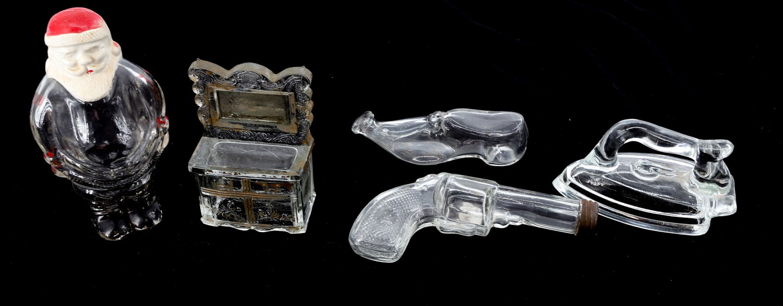 LOT OF GLASS CANDY CONTAINERS: (4) INCLUDING SIDEBOARD W/ MIRROR, SANTA CLAUS 5 3/4" H., IRON AND PISTOL W/ TIN CAP. PLUS, SHOE FLASK. PLEASE READ CAREFULLY - Terms for Purchasing and Shipping of Auction Items. Please read carefull