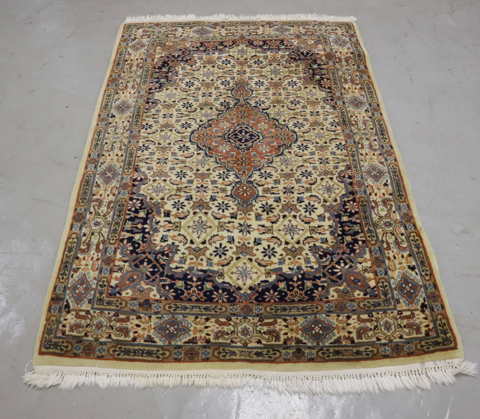 ORIENTAL THROW RUG: BLUE/CREAM/BROWN/RUST WITH FRINGE. CENTER MEDALLION WITH FLORAL/LEAF PATTERN THROUGHOUT. 75" X 49". PLEASE READ CAREFULLY - Terms for Purchasing and Shipping of Auction Items. Please read carefully be