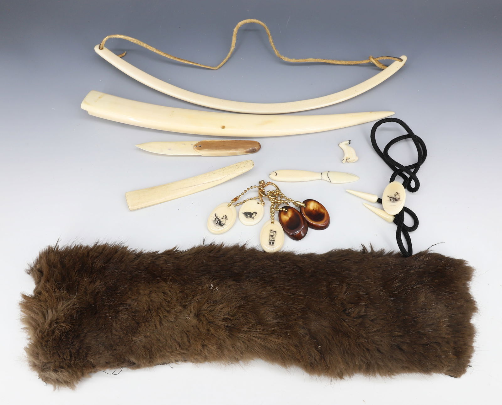 LOT OF ESKIMO / INUIT ART: CARVED BONE CRIBBAGE BOARD 15" L., KEYCHAINS, LETTER OPENER AND MORE. PLEASE READ CAREFULLY - Terms for Purchasing and Shipping of Auction Items. Please read carefully before bidding. Hartzell?s Aucti