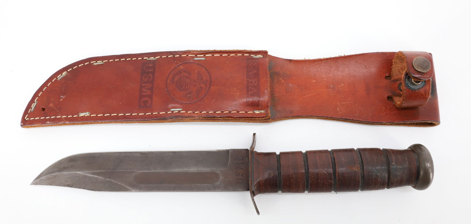 U.S.M.C. KNIFE AND SHEATH: KA-BAR KNIFE MARKED U.S.M.C. WITH LEATHER SHEATH, 7" BLADE PLEASE READ CAREFULLY BEFORE BIDDING. ALL PAYMENTS MUST BE MADE BEFORE ITEMS CAN BE SHIPPED. BUYERS CAN PAY VIA LIVE AUCTIONEERS PAYMENT CENT