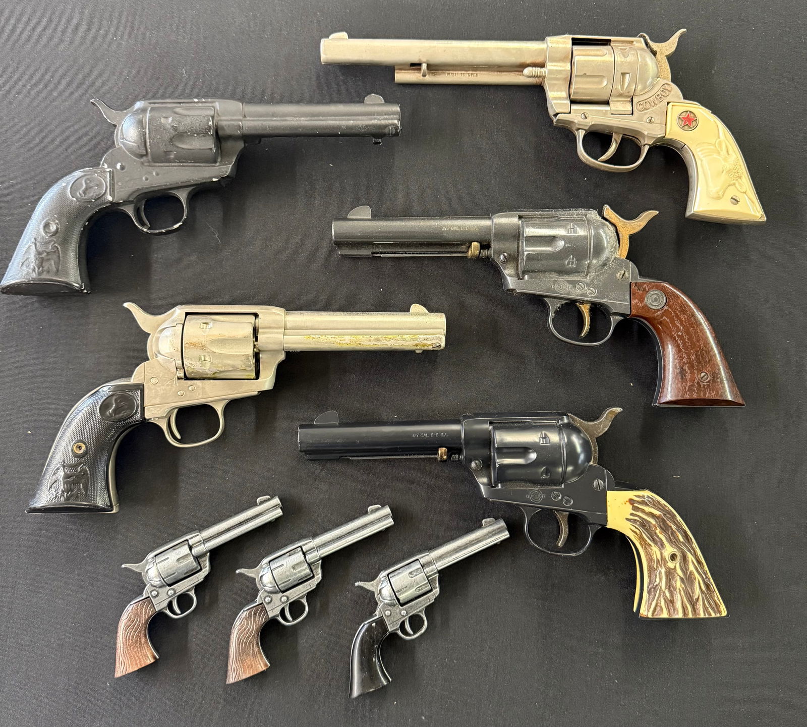 LOT OF MODEL / PROP GUNS: (8) INCLUDING: DAISY, COWBOY, ONE MRKD. PAT. 1875 AND THREE MINIS.