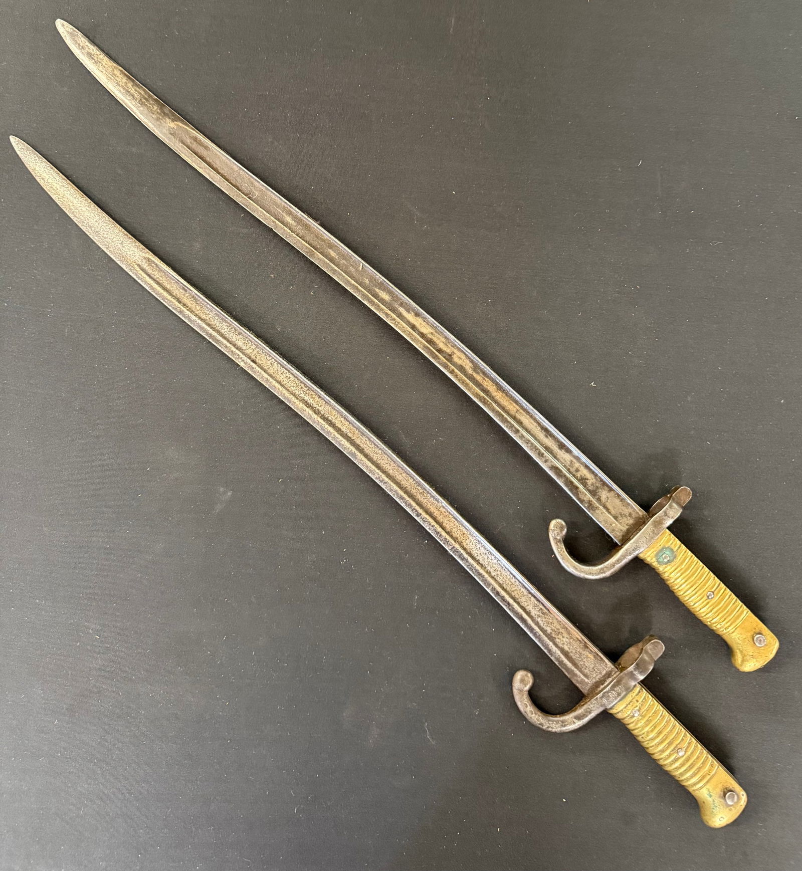 (2) 19TH CENTURY FRENCH CHASSEPOT BAYONETS: BRASS HANDLES WITH SERIAL# D 35798 AND 45177