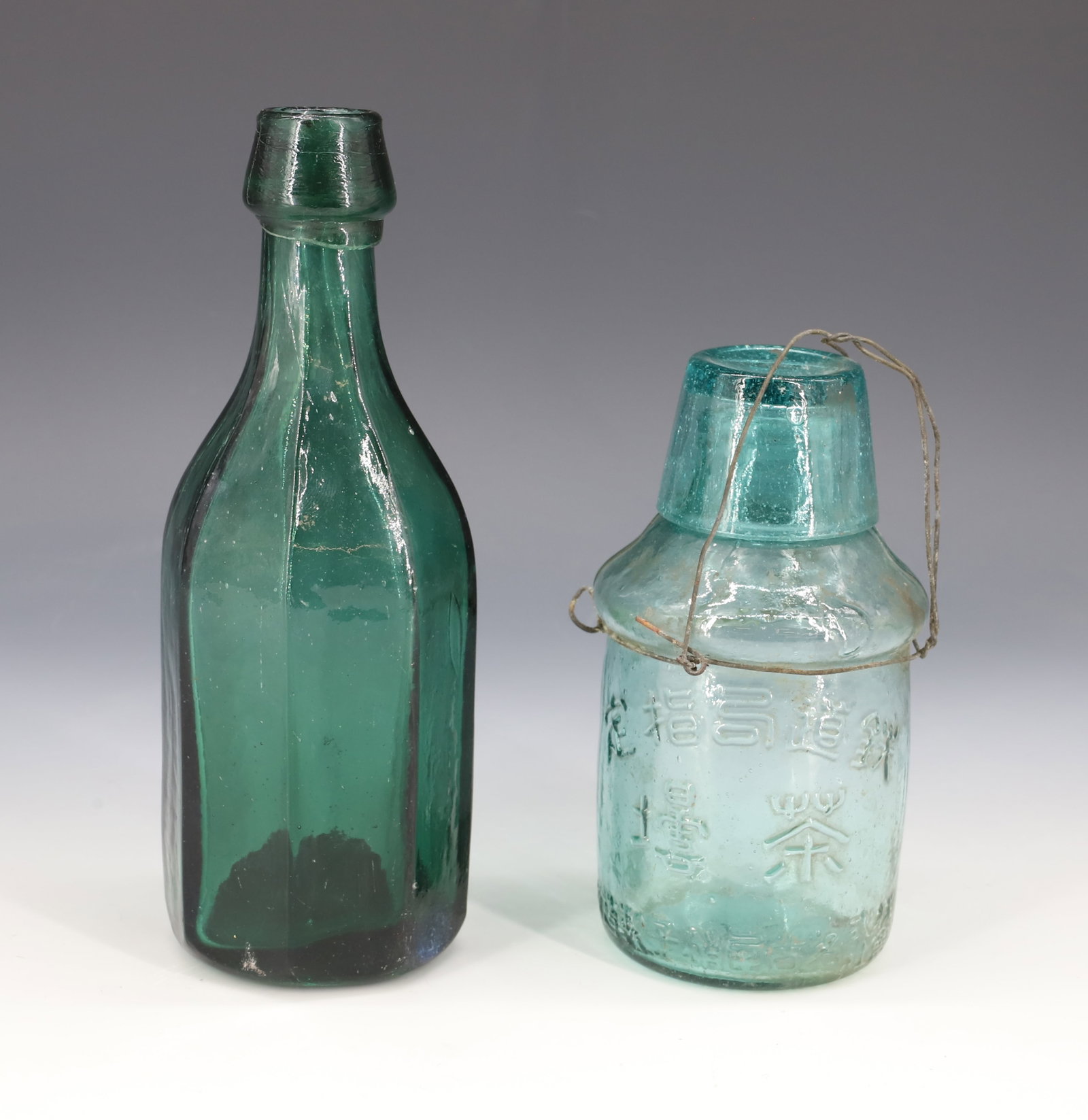 OCTAGONAL SIDED BOTTLE AND JAPANESE LIDDED POT: GREEN FLAT SIDED BOTTLE WITH APPLIED TOP. 7 1/4" H. PLUS, JAPANESE AQUA BOTTLE WITH CUP/LID AND WIRE ENCLOSURE.