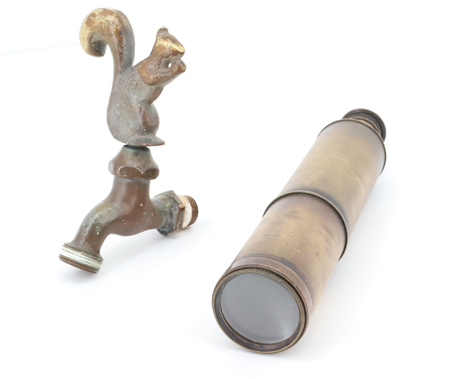 BRASS SPYGLASS AND SQUIRREL FAUCET: BRASS SPYGLASS 32 1/4" WHEN EXTENDED. WITH, HEAVY BRASS SQUIRREL HANDLE FAUCET. 6" X 4".