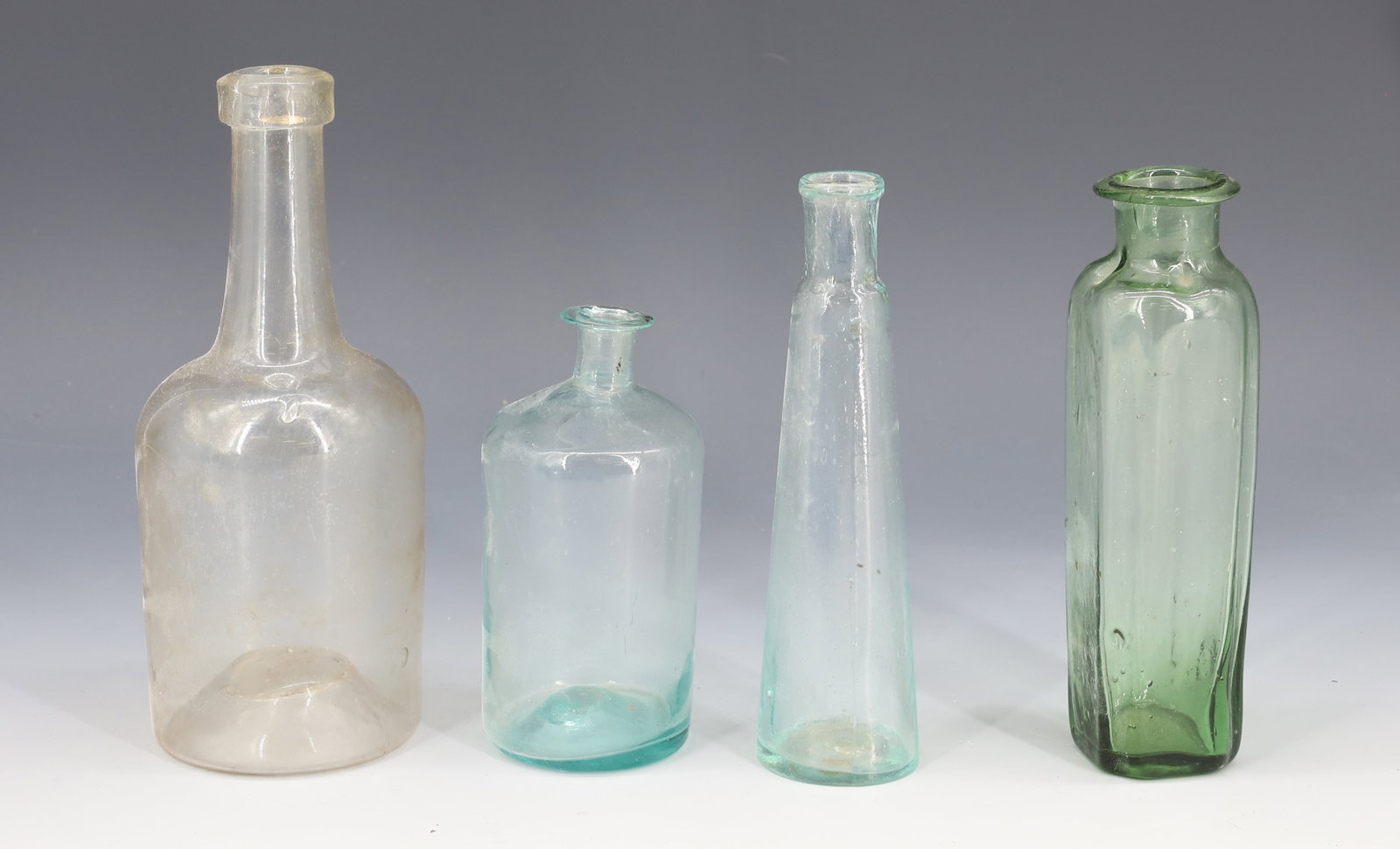 LOT OF BLOWN GLASS BOTTLES: VARIOUS SIZES, SHAPES AND COLORS. 4" TO 6 1/8" HEIGHTS.
