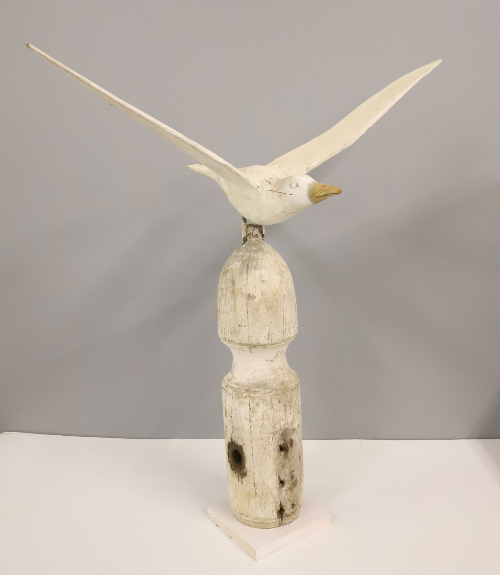 PAINTED WOODEN SEAGULL: PERCHED ON WOODEN BASE. 29" X 24 1/2" TOTAL SIZE.