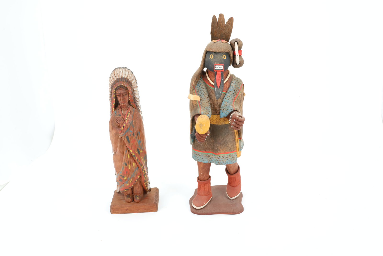 CARVED INDIAN CHIEF AND HOPI KACHINA DOLL BY C. CARL M.: CARVED AND PAINTED INDIAN CHIEF. 10 3/4" H. KACHINA MRKD. "CHAKWEINA SHO-ADTA, GRANDMOTHER" ON BOTTOM. 14" H.