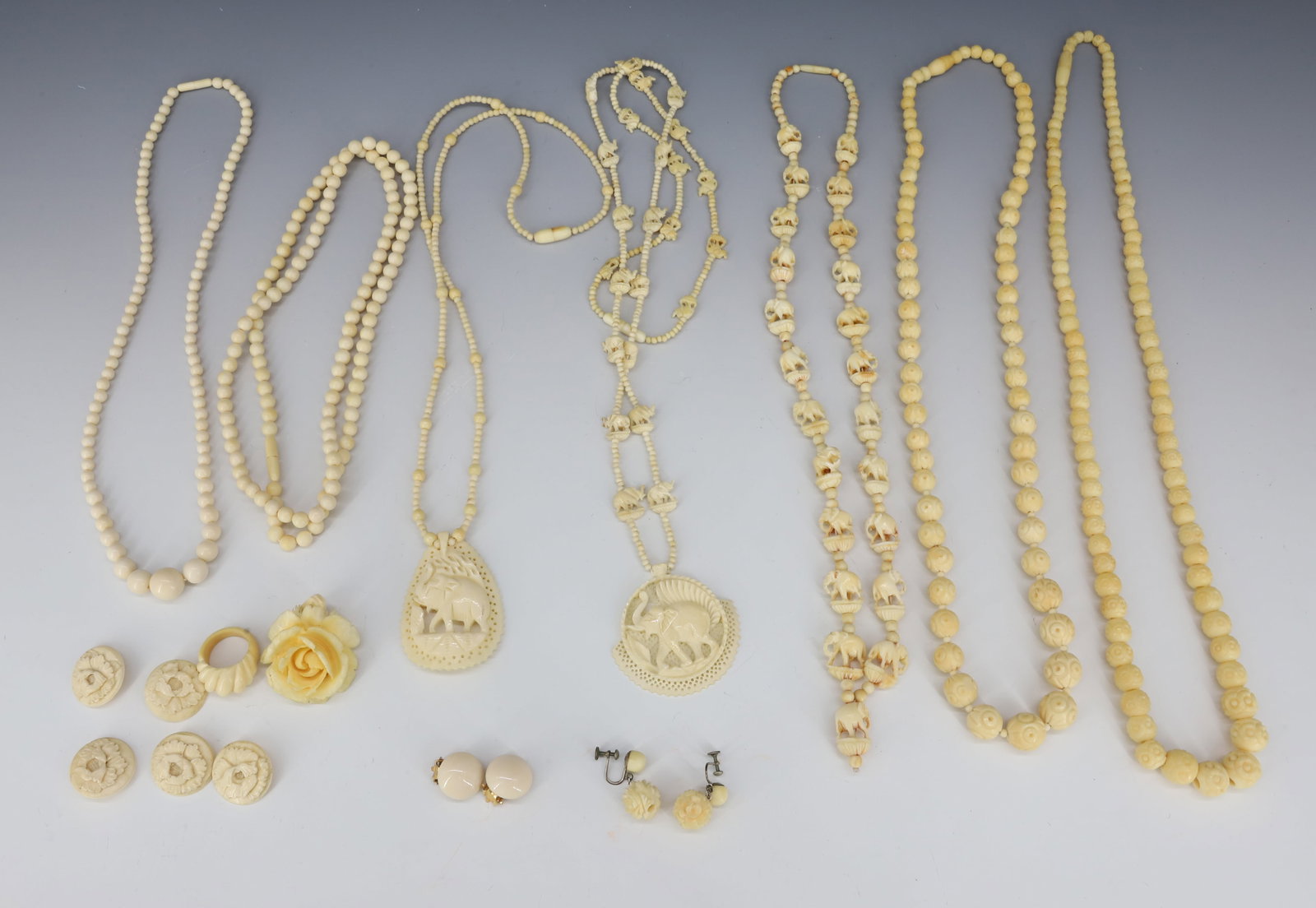 CARVED BONE JEWELRY LOT: (7) NECKLACES SOME WITH ELEPHANTS, CARVED ROSE PENDANT, RING, (5) BUTTONS, 18 TO 24" PLEASE READ CAREFULLY - Terms for Purchasing and Shipping of Auction Items. Please read carefully before bidding. H
