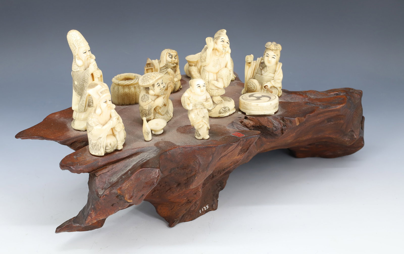 ANTIQUE JAPANESE CARVINGS: 19TH / EARLY 20TH C. CARVED BONE "ENTERTAINERS" MOUNTED ON FREE-FORM WOOD BASE. TALLEST FIGURE IS 3 1/8" H. WOOD BASE IS 13 1/2" L. PLEASE READ CAREFULLY - Terms for Purchasing and Shipping of Auction