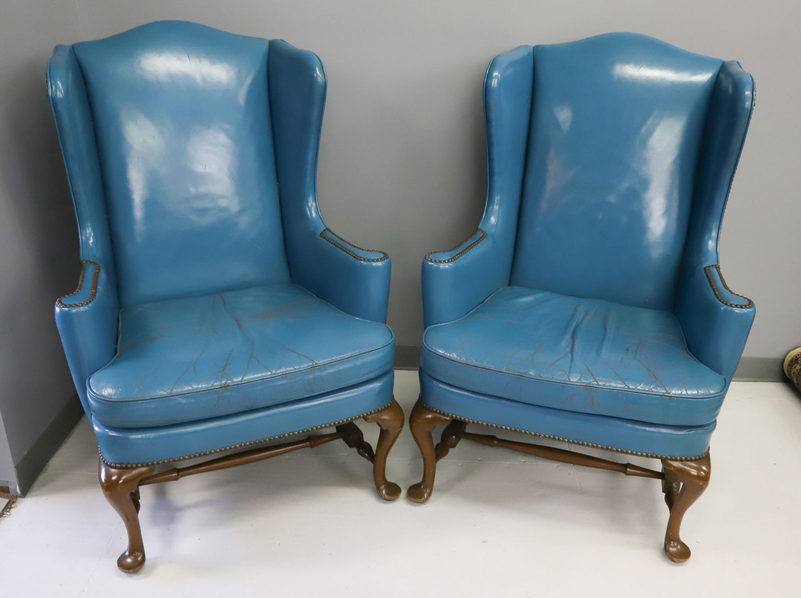 (2) ROYAL BLUE LEATHER ARM CHAIRS: WING BACKS WITH CABRIOLE LEGS LEATHER COVERINGS 46" X 32" X 30" PLEASE READ CAREFULLY - Terms for Purchasing and Shipping of Auction Items. Please read carefully before bidding. Hartzell’s Auction G