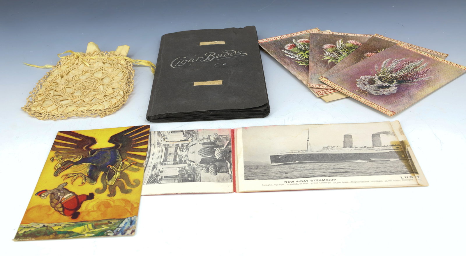 CIGAR BAND ALBUM, HIGHLANDER POSTCARDS: CIGAR BAND ALBUM (32) PAGES ENDING WITH PATRIOTIC PRESIDENT BANDS, (5) TUCK'S POSTCARDS (4) HIGHLANDER AND ONE POLITICAL, LUSITANIA POSTCARD WITH FOLD OUTS OF SHIP , CROCHETED PURSE LARGEST ALBUM 7 3/