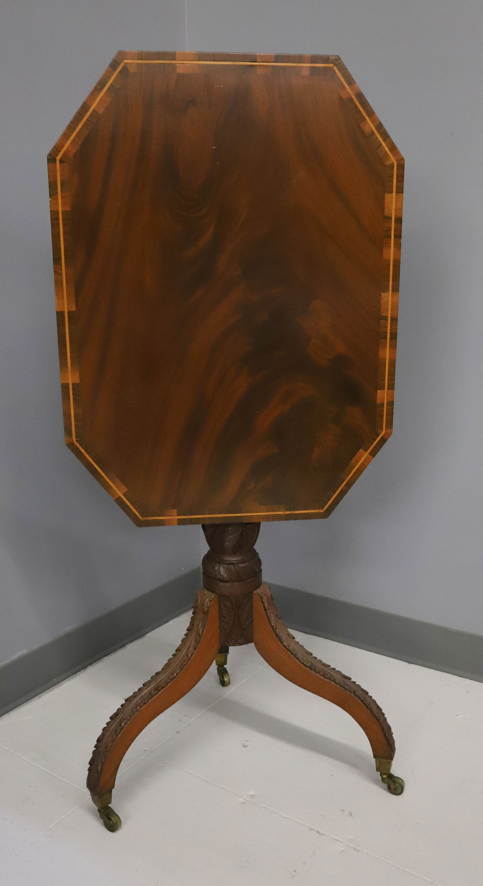 REGENCY STYLE OCTAGONAL FLIP TOP TABLE: DUNCAN PHYFE BASE WITH HEAVILY CARVED POST, BANDED INLAY MAHOGANY TOP - 30" X 25" X 18 1/4" (TOP DOWN) PLEASE READ CAREFULLY - Terms for Purchasing and Shipping of Auction Items. Please read carefully