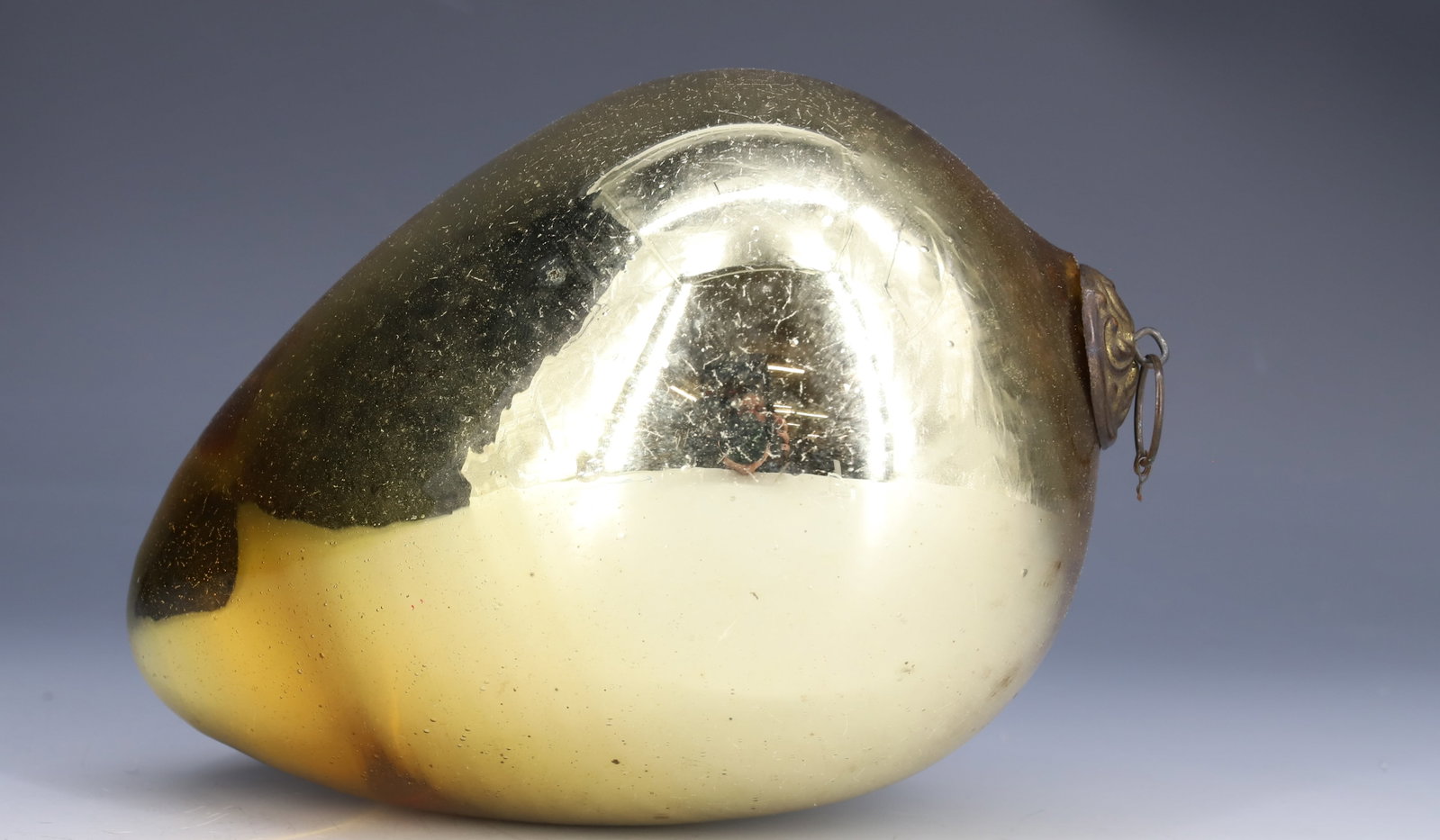 ANTIQUE EGG-SHAPED KUGEL: GOLD TO LIGHT GOLD COLOR. 5 1/2" L. PLEASE READ CAREFULLY - THIS IS AN ONLINE ONLY AUCTION -Terms for Purchasing and Shipping of Auction Items. Please read carefully before bidding. Hartzell?s Auction