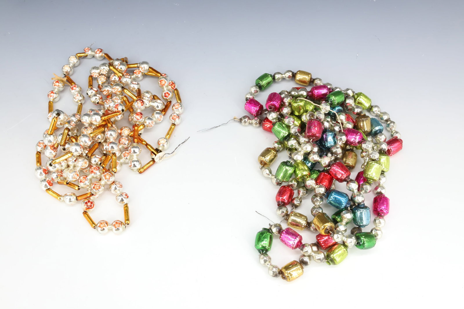 (2) STRANDS OF VINTAGE GLASS CHRISTMAS BEADS, GARLAND: MULTI-COLOR AND SHAPE BEADS WITH SILVER/GOLD MULTI-SHAPE STRAND. PLEASE READ CAREFULLY - THIS IS AN ONLINE ONLY AUCTION -Terms for Purchasing and Shipping of Auction Items. Please read carefully befor