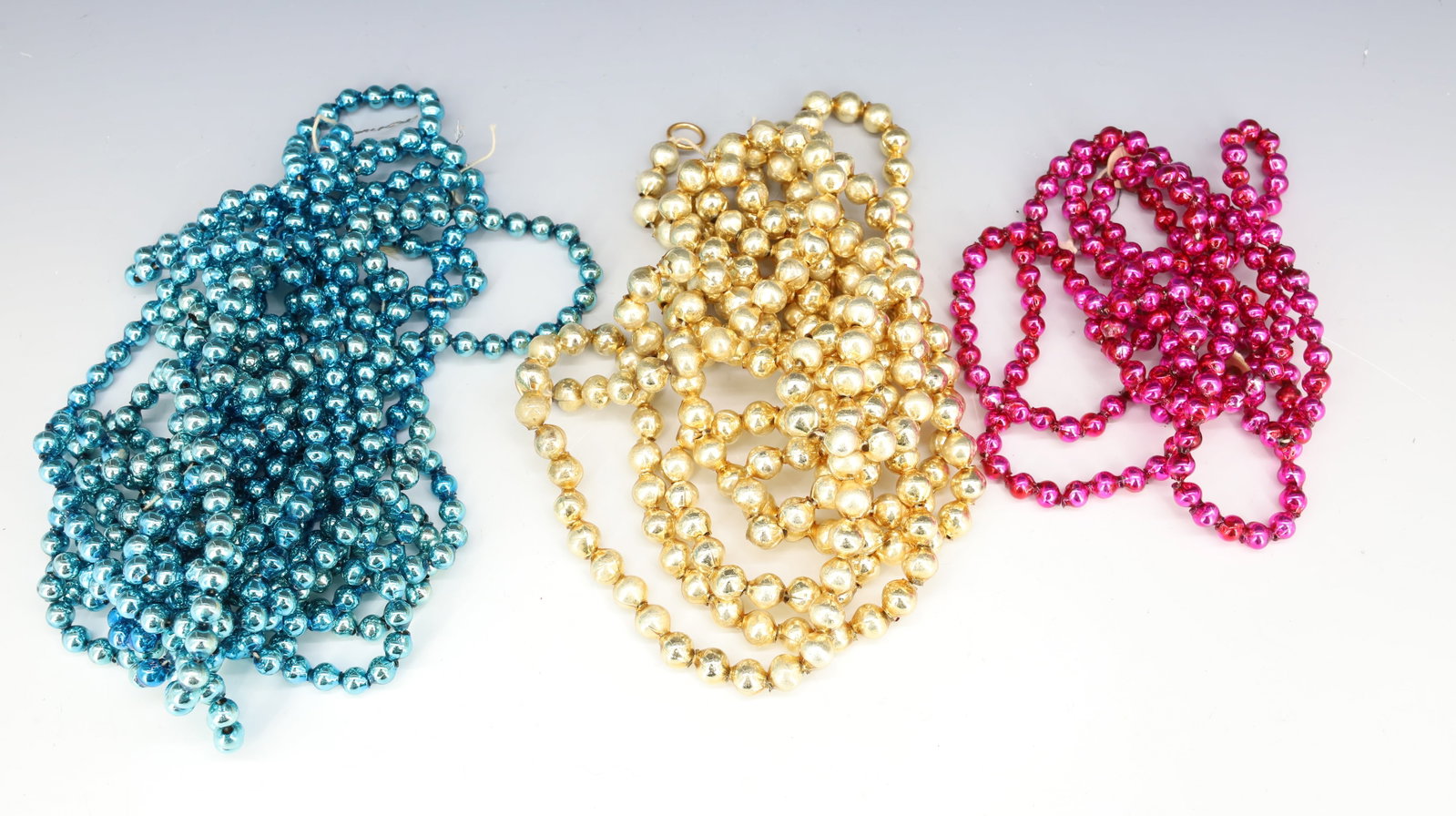 LOT OF VINTAGE GLASS CHRISTMAS BEADS, GARLAND: (3) TOTAL STRANDS OF BLUE / GOLD / PURPLE. PLEASE READ CAREFULLY - THIS IS AN ONLINE ONLY AUCTION -Terms for Purchasing and Shipping of Auction Items. Please read carefully before bidding. Hartzell?s 