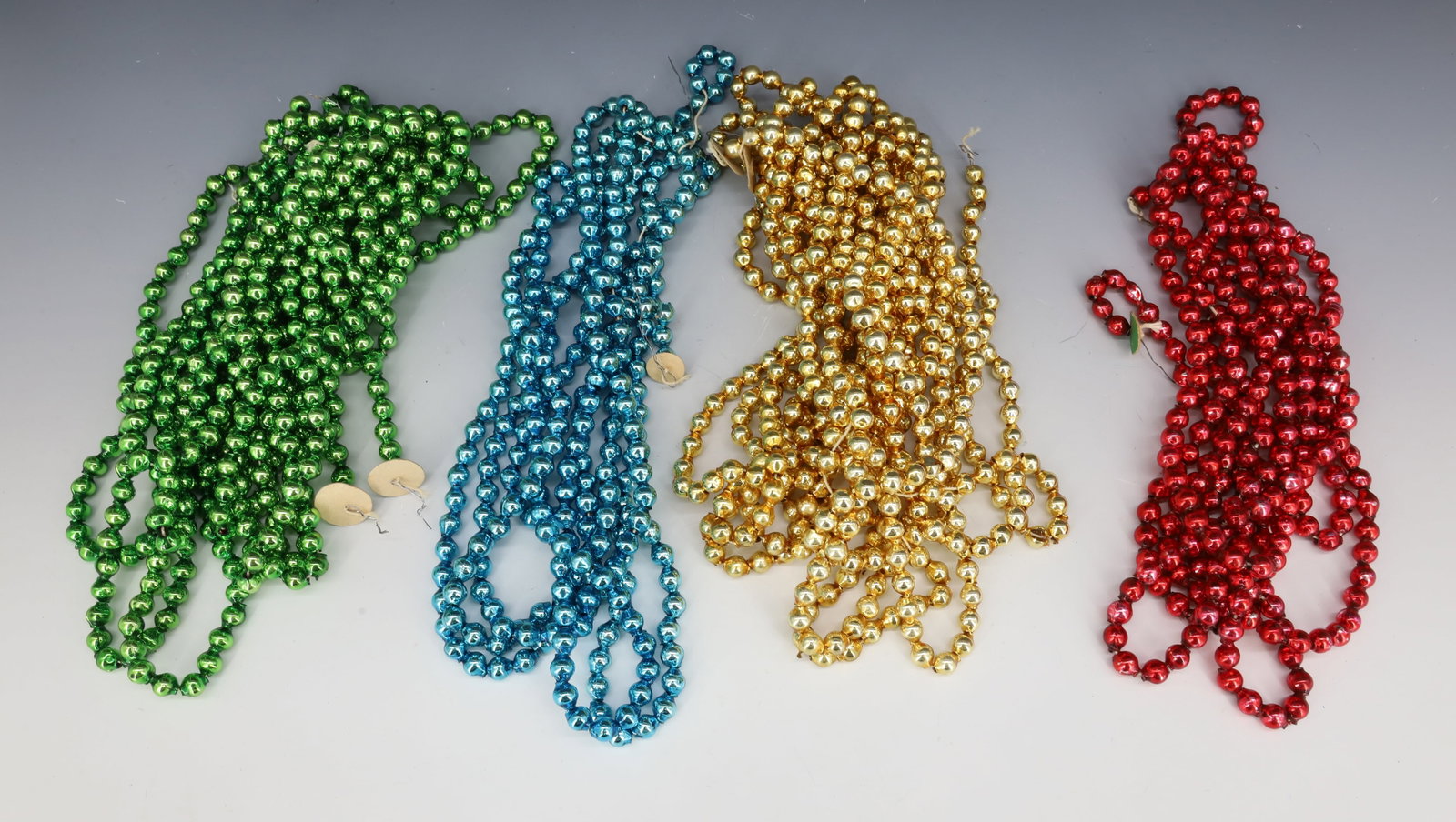 LOT OF VINTAGE GLASS CHRISTMAS BEADS, GARLAND: (4) TOTAL STRANDS OF RED, GOLD, BLUE AND GREEN. PLEASE READ CAREFULLY - THIS IS AN ONLINE ONLY AUCTION -Terms for Purchasing and Shipping of Auction Items. Please read carefully before bidding. Hartze