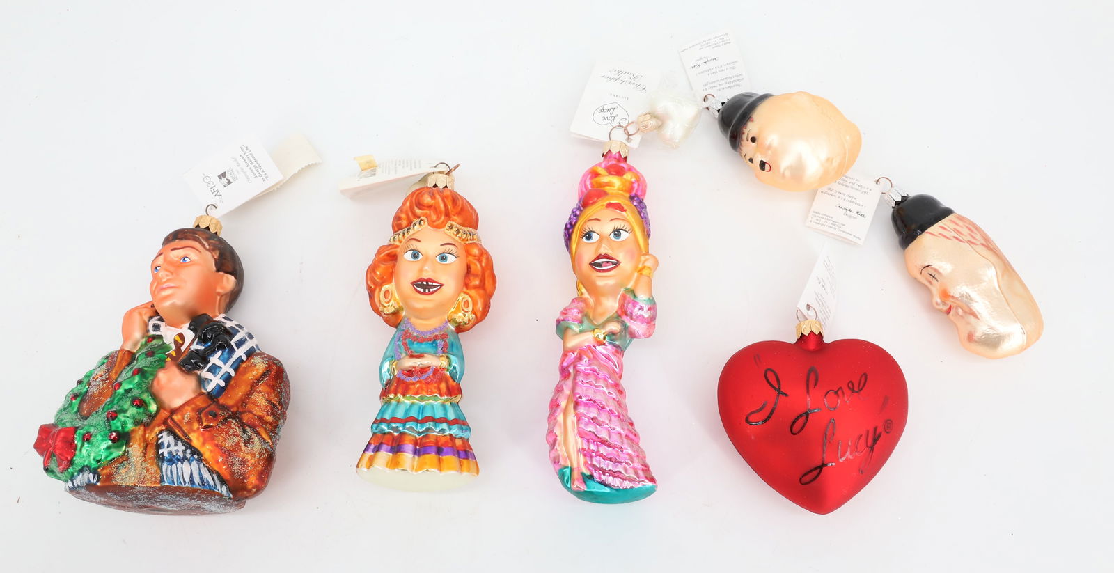(6) VINTAGE CHRISTOPHER RADKO GLASS ORNAMENTS: INCLUDING: I LOVE LUCY (LUCY OLE, GYPSY LUCY AND HEART), JAMES STEWART (AS GEORGE BAILEY "IT'S A WONDERFUL LIFE). ALL IN ORIGINAL BOXES. PLUS, LAUREL AND HARDY (NO BOXES). ALL HAVE ORIGINAL TAGS. PLEA
