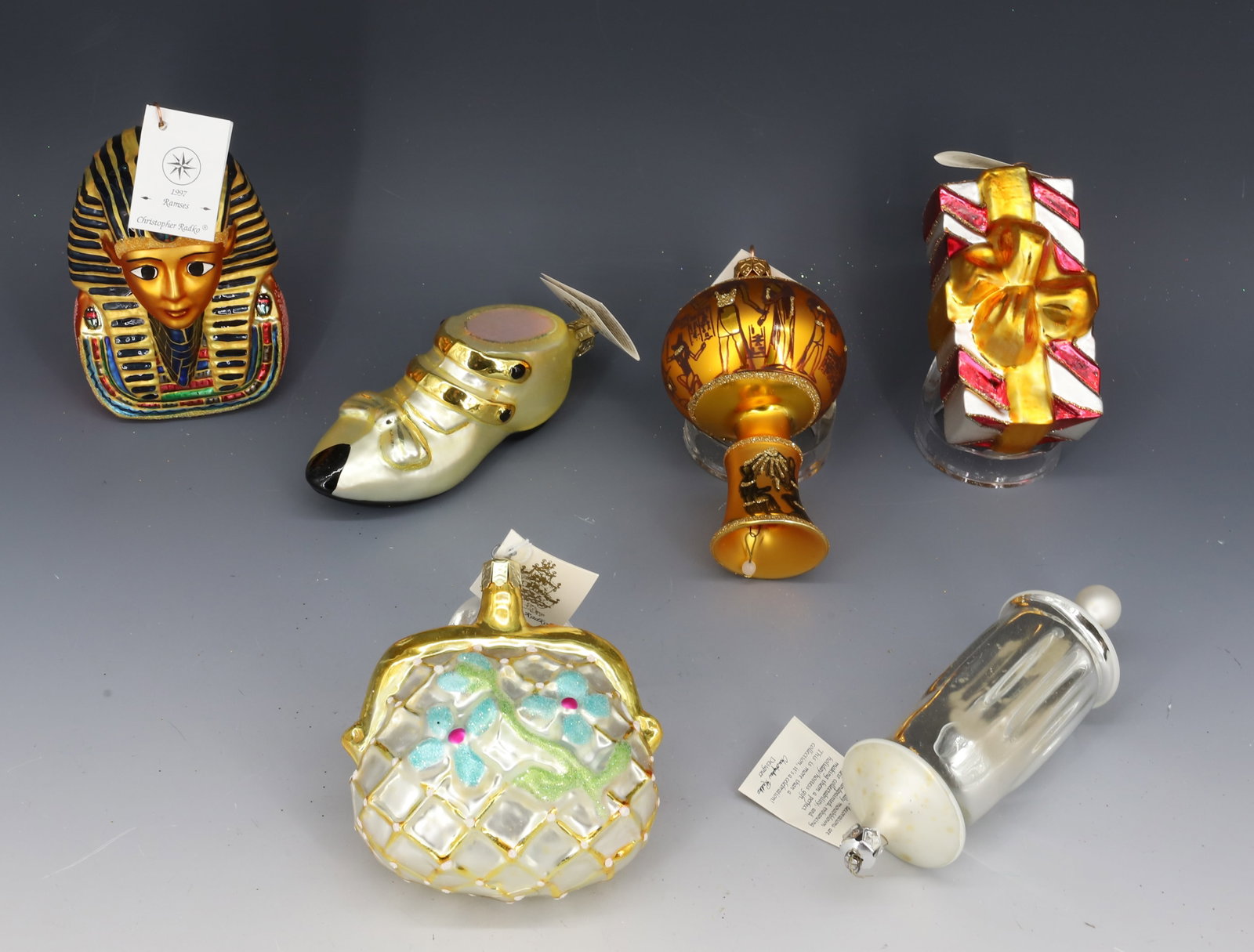 (6) VINTAGE CHRISTOPHER RADKO GLASS ORNAMENTS: INCLUDING: RAMSES (ORIGINAL BOX, 1997), EGYPT RINGS (CZECH REPUBLIC), SHOE, PURSE, PRESENT 4" L. AND MORE. PLEASE READ CAREFULLY - THIS IS AN ONLINE ONLY AUCTION -Terms for Purchasing and Shipping of 