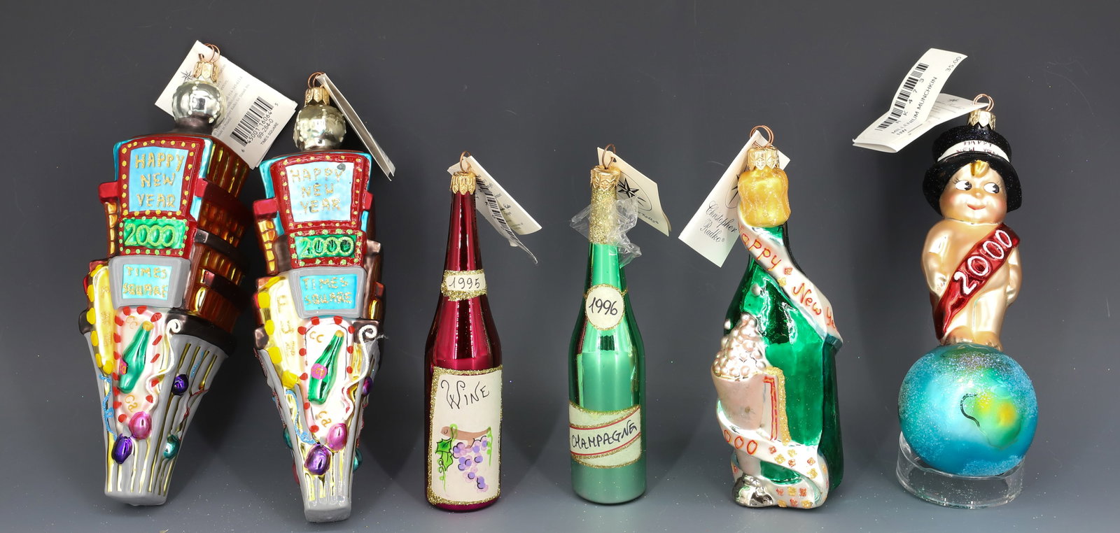 (6) VINTAGE CHRISTOPHER RADKO GLASS ORNAMENTS: NEW YEAR'S THEMED ORNAMENTS INCLUDING: CHAMPAGNE BOTTLES, TIMES SQUARE AND MORE. MADE IN POLAND / ITALY. LARGEST 8" L. PLEASE READ CAREFULLY - THIS IS AN ONLINE ONLY AUCTION -Terms for Purchasing and 