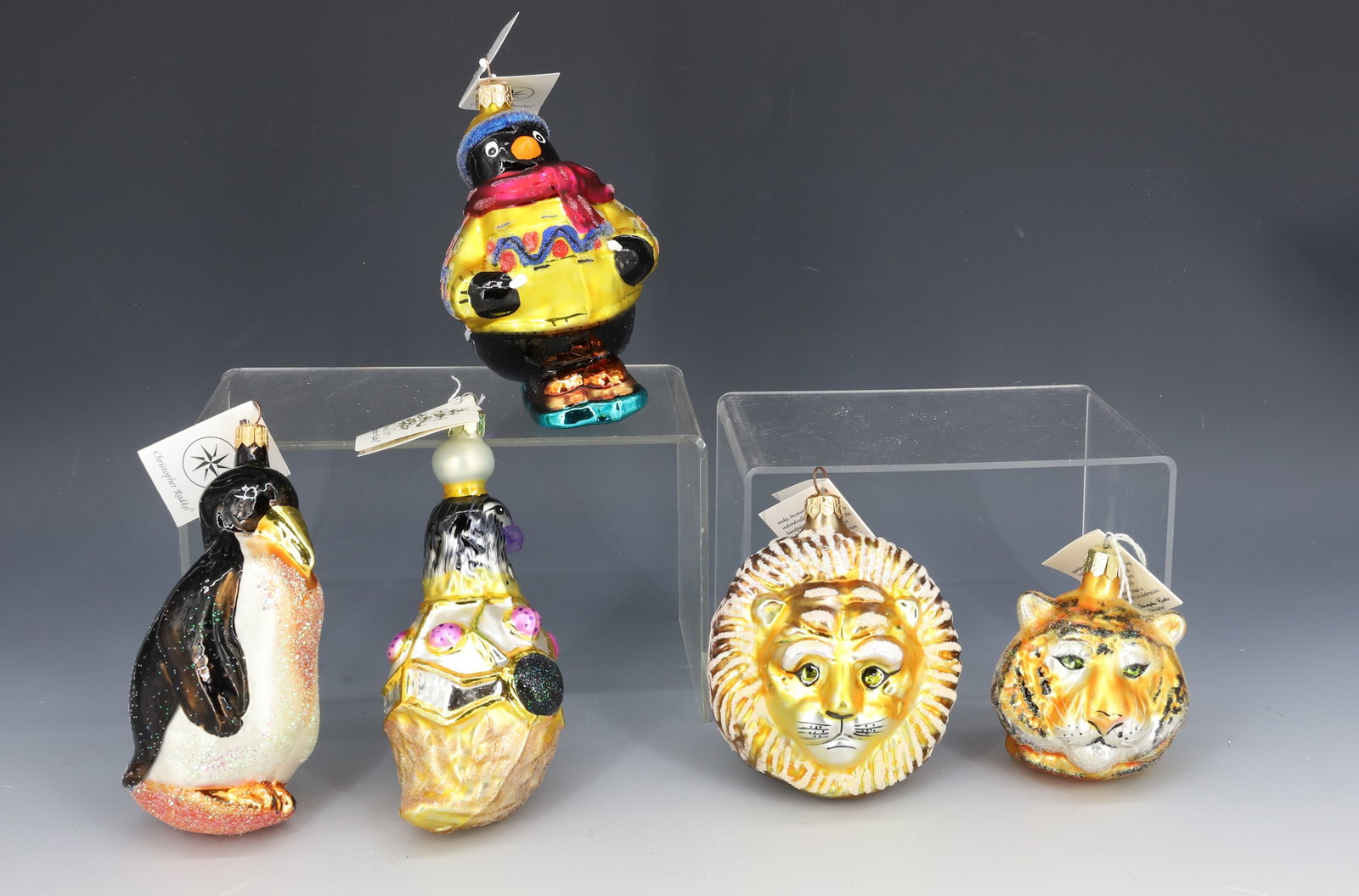 (5) VINTAGE CHRISTOPHER RADKO GLASS ORNAMENTS: INCLUDING: THREE PENGUINS, LION AND TIGER. ORIGINAL TAGS. MADE IN POLAND. LARGEST 5" L. PLEASE READ CAREFULLY - THIS IS AN ONLINE ONLY AUCTION -Terms for Purchasing and Shipping of Auction Items. Plea