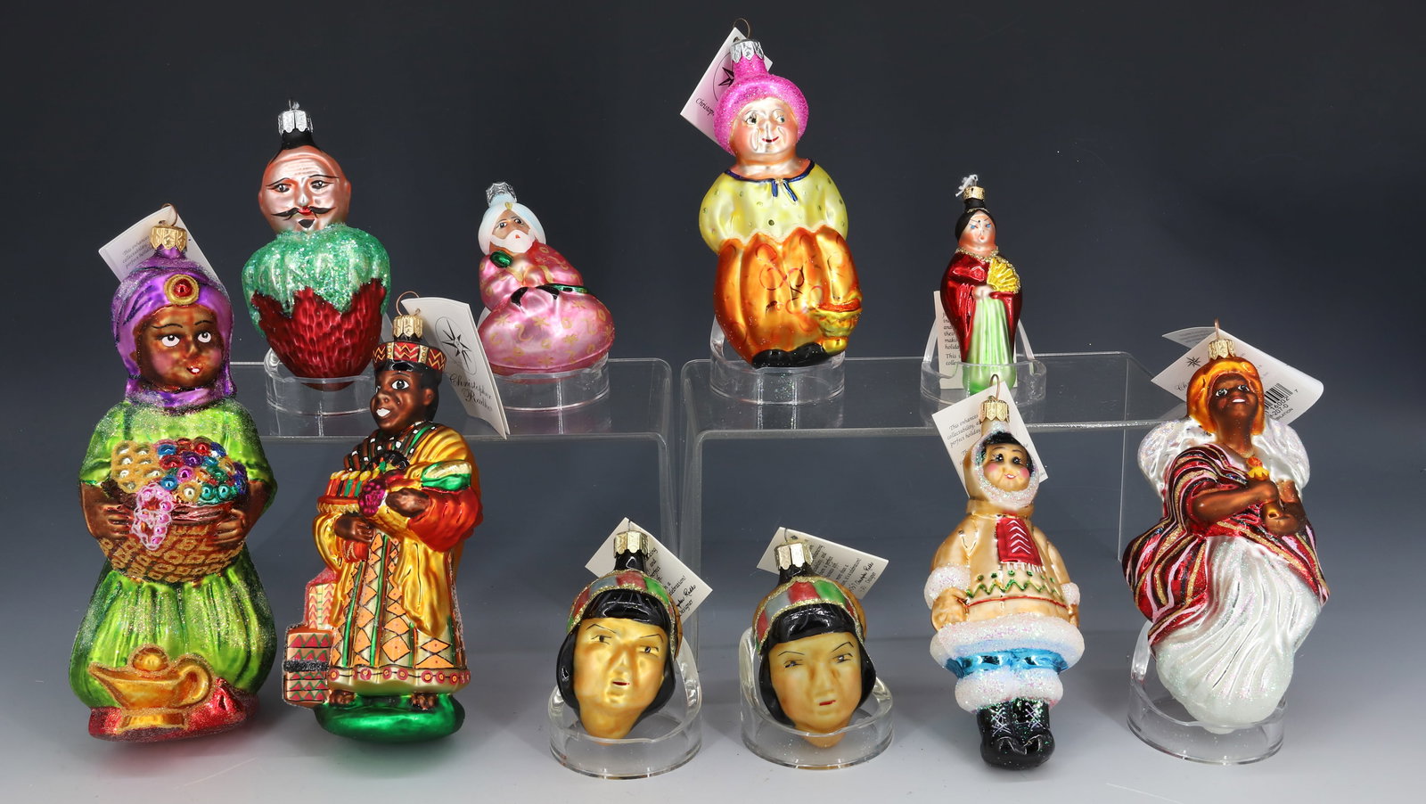 (10) VINTAGE CHRISTOPHER RADKO GLASS ORNAMENTS: VARIOUS ETHNIC ORNAMENTS INCLUDING: ESKIMO, APACHE, JAPANESE, KWANZAA AND MORE. ORIGINAL TAGS. LARGEST 7 1/4" H. PLEASE READ CAREFULLY - THIS IS AN ONLINE ONLY AUCTION -Terms for Purchasing and Shippi