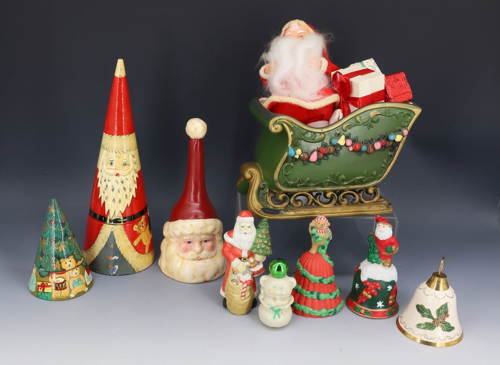 LOT OF VINTAGE / CONTEMPORARY CHRISTMAS DECORATIONS: INCLUDING: NESTING SANTA CLAUS AND TREES, VARIETY OF BELLS, SANTA MRKD. JAPAN AND CERAMIC SLEIGH. PLEASE READ CAREFULLY - THIS IS AN ONLINE ONLY AUCTION -Terms for Purchasing and Shipping of Auction I