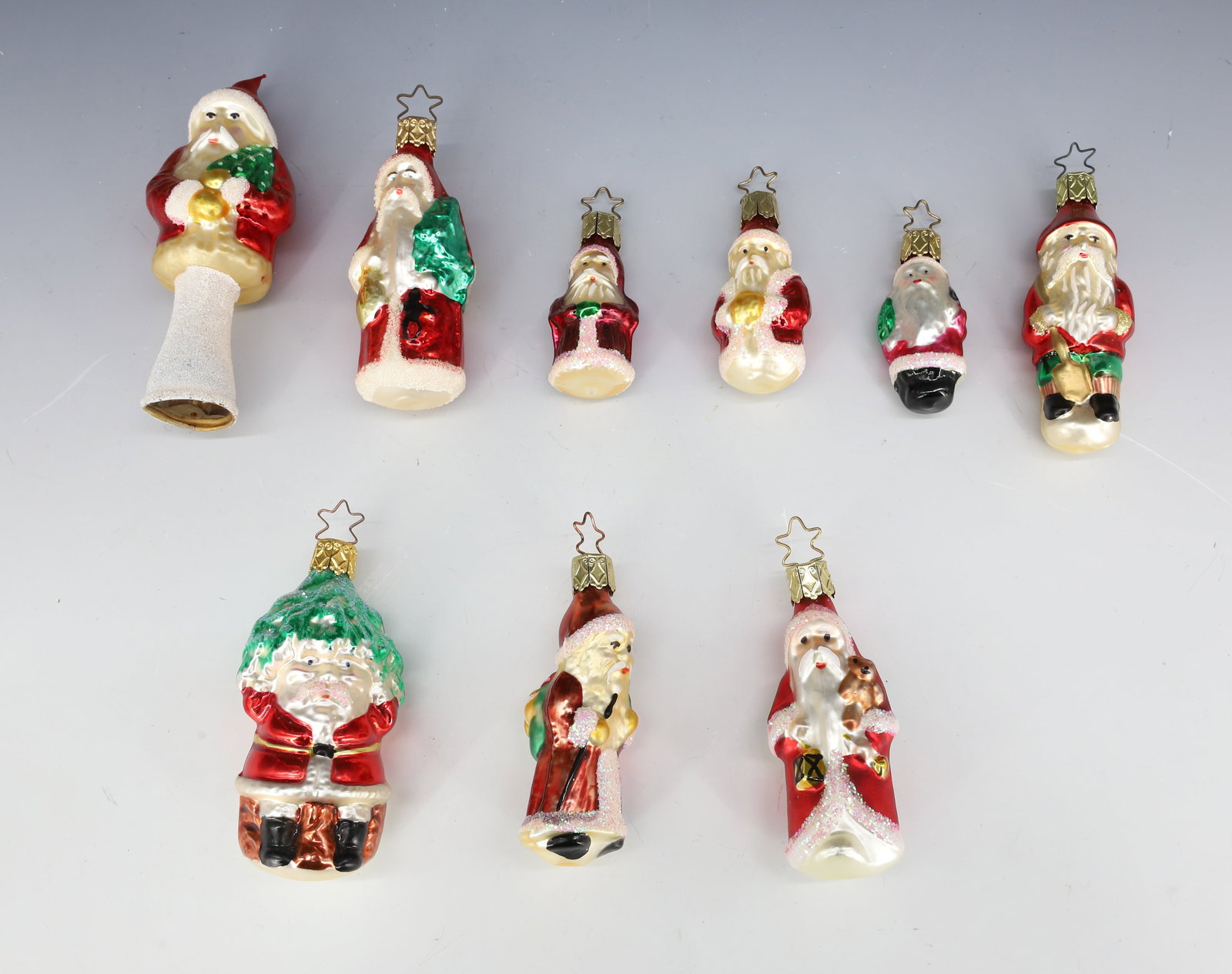 LOT OF GLASS SANTA CLAUS ORNAMENTS: EIGHT ORNAMENTS AND ONE TREE TOPPER 4 3/4" H. PLEASE READ CAREFULLY - THIS IS AN ONLINE ONLY AUCTION -Terms for Purchasing and Shipping of Auction Items. Please read carefully before bidding. Hartzell