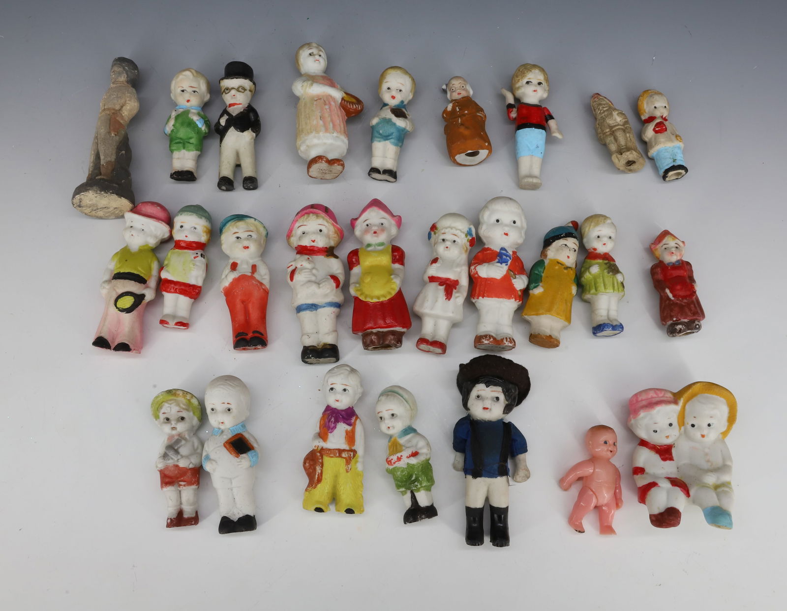 LARGE LOT OF BISQUE FIGURES: VARIETY OF CHILDREN IN VARIOUS POSES WITH PAINTED HIGHLIGHTS. LARGEST 3 3/4" H. PLEASE READ CAREFULLY - THIS IS AN ONLINE ONLY AUCTION -Terms for Purchasing and Shipping of Auction Items. Please read