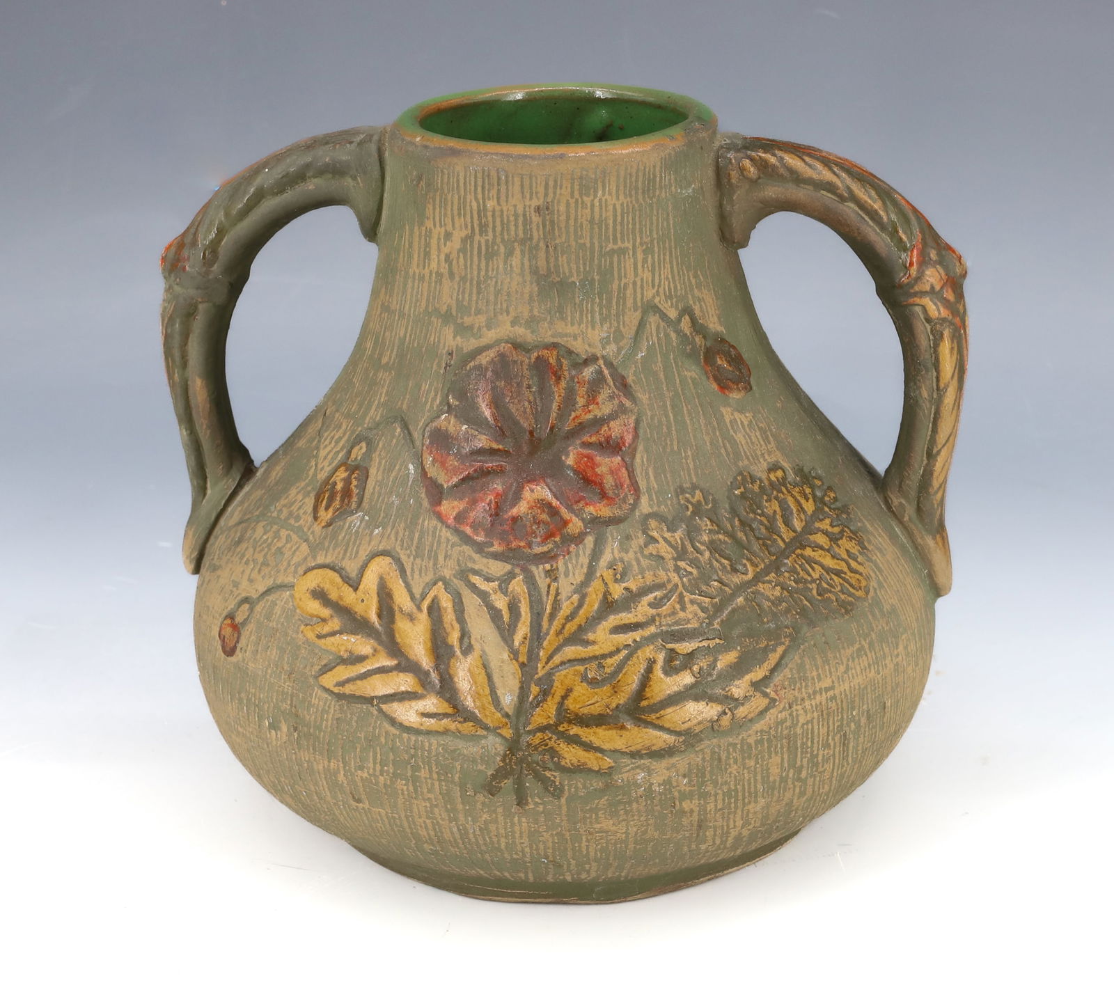 "RED WING" POTTERY VASE: MOLDED DOUBLE-HANDLE VASE WITH FLORAL MOTIF. STAMPED ON BOTTOM. 6 1/2" H. PLEASE READ CAREFULLY - Terms for Purchasing and Shipping of Auction Items. Please read carefully before bidding. Hartzell?s A